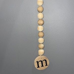 Wall hanging with the letter M.